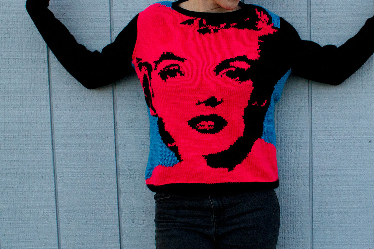 a boxy sweater with andy warhol inspired marilyn monroe pop art in neon pink and blue