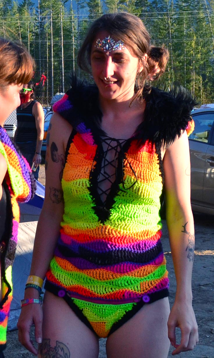 stephanie wearing a crocheted, neon rainbow body suit