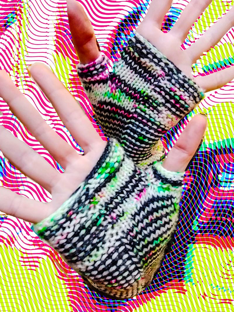 black and white striped arm warmers with neon green and pink speckles