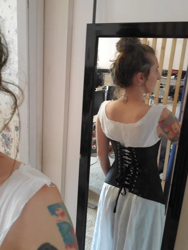 Back mirror selfie showing plunge neck corset