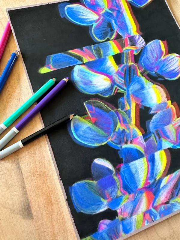 lupine painting next to pastel pencils