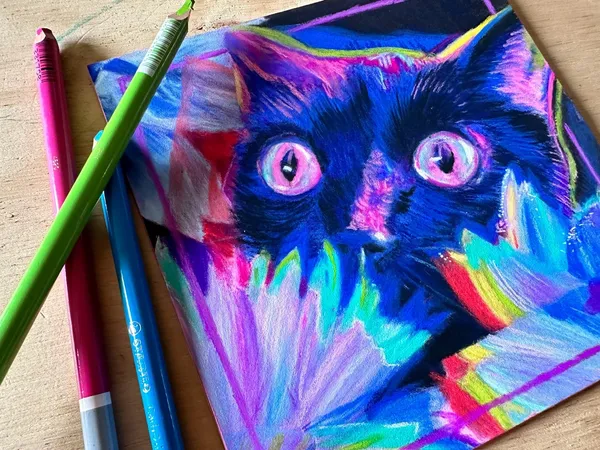 soft pastel cat next to Carbothello pastel pencils