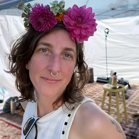 Stephanie Paulantis with bright pink flowers in her hair