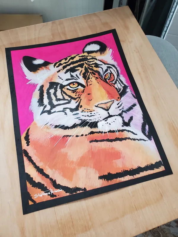 Zoomed out view of tiger painting on a table